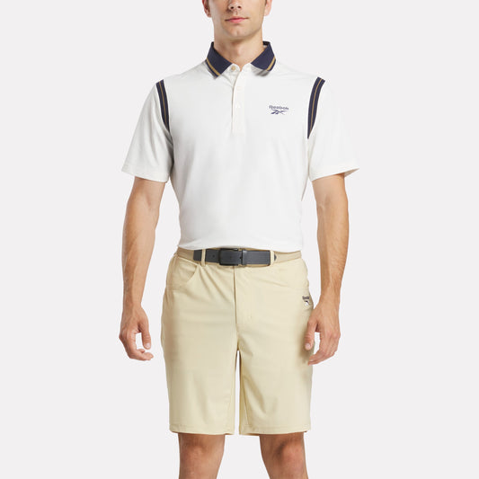 REEBOK APPAREL MEN Varsity Golf Short Sleeve Polo CHALK/GOLD/VECTOR NAVY